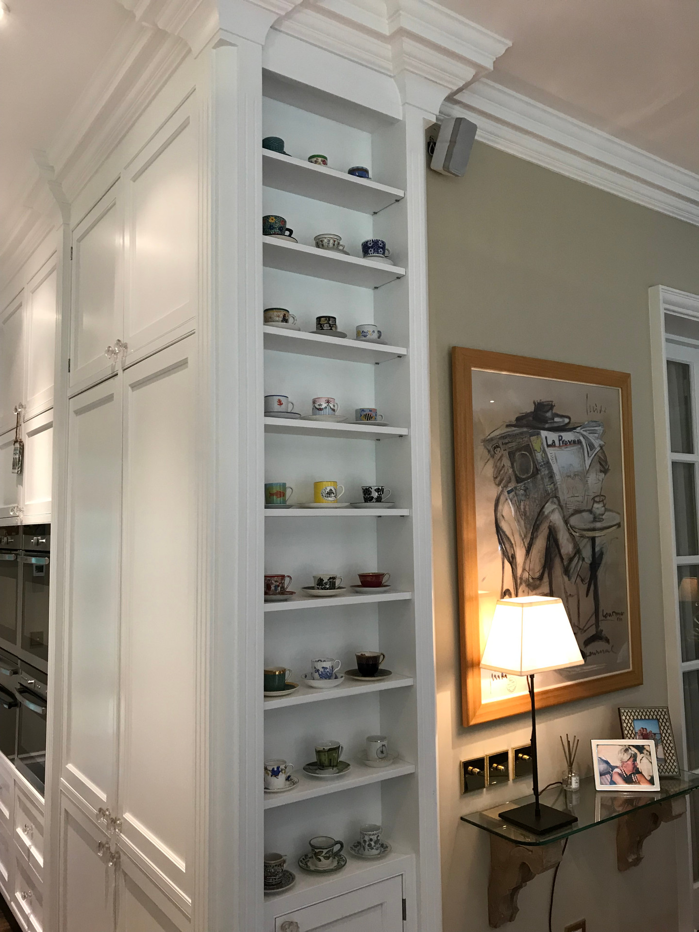 Display shelves disguising the side of a fridge